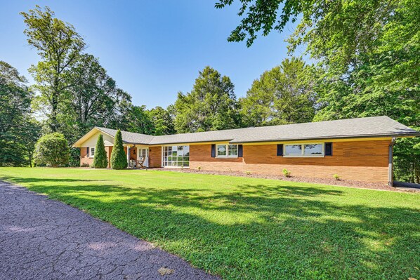 A two-story house with a brick exterior, a front porch, and a well-maintained lawn. - Golf Course Views & Games Galore - Vine Grove Gem! (Vine Grove)