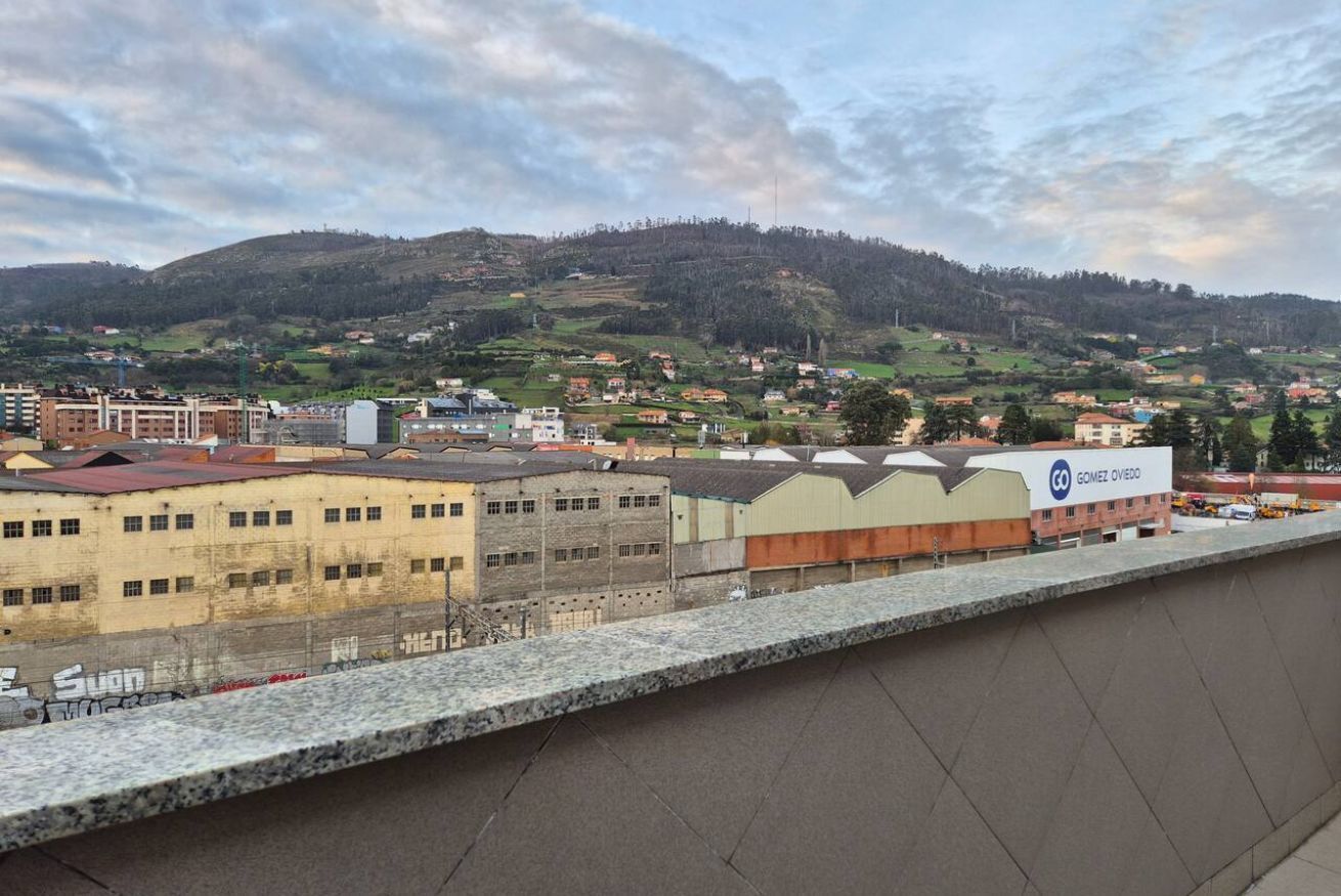 Une vue d’une ville avec des bâtiments, une colline et un panneau indiquant « Gomez Ovejo ».