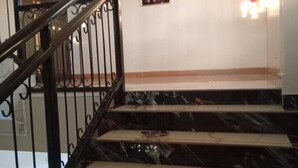 A staircase with black metal railings and marble steps. - Stunning Studio Apartment on Entebbe that is fully furnished and accessible (Namulanda)
