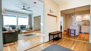 A modern apartment with a living room, kitchen, and dining area. - Home in Heart of Downtown North Conway (Conway)