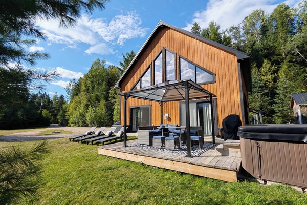 Deck, sectional, dining table, lounge chairs, hot tub, gazebo