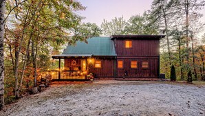 A cabin with a porch, a covered deck, and a fenced yard. - Secluded 3 Bedroom Cabin w/hot tub in the mountains of Clayton, Ga (Clayton)