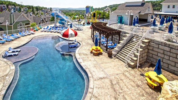 Un parc aquatique doté d’une piscine, de chaises longues et d’un espace de repos abrité.