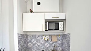 A compact kitchenette with a microwave, a small sink, and a refrigerator. - Studio Cozy Ivry near Paris (Ivry-sur-Seine)