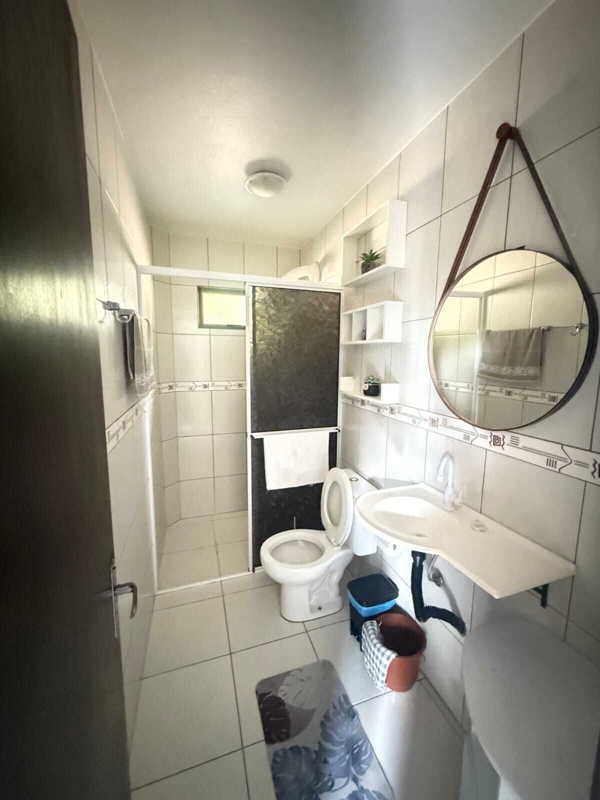 A bathroom with a toilet, sink, and shower.