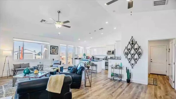 A spacious living area with a black leather sofa, a dining table, and a kitchen in the background. - The Grape Escape/Luxury Stay/Views/Walk 2 Old Town (Cottonwood)