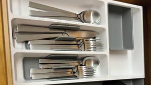 A drawer with utensils and wooden spoons organized in compartments. - Cozy house (Jersey City)