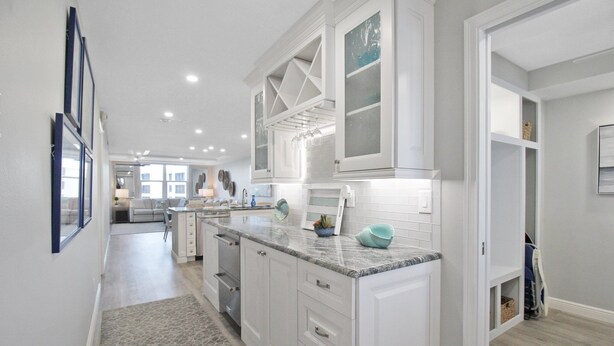 A modern kitchen with white cabinetry, granite countertops, and a central island. - Luxurious 2BR Gulfview Condo On Siesta Key Steps To The Beach Gulf Horizon (Sarasota)