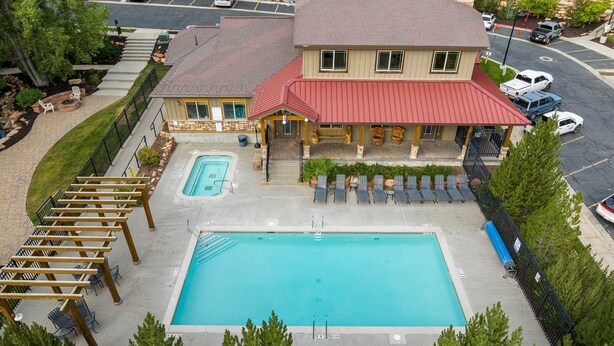 A hotel with a swimming pool, outdoor seating, and a covered patio area. - Bear Hollow Basecamp, Hot Tub, Balconies, Pool Clubhouse (Park City)