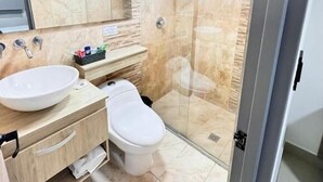 A modern bathroom with a glass-enclosed shower, a large sink, and a toilet. - HOTEL FENIX REAL (Bogotá)