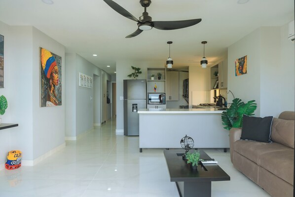 A modern living room with a sofa, coffee table, and artwork on the walls. - Cartagena Gem, Fully Renovated Retreat Just Minutes from Playa Hollywood (Cartagena)