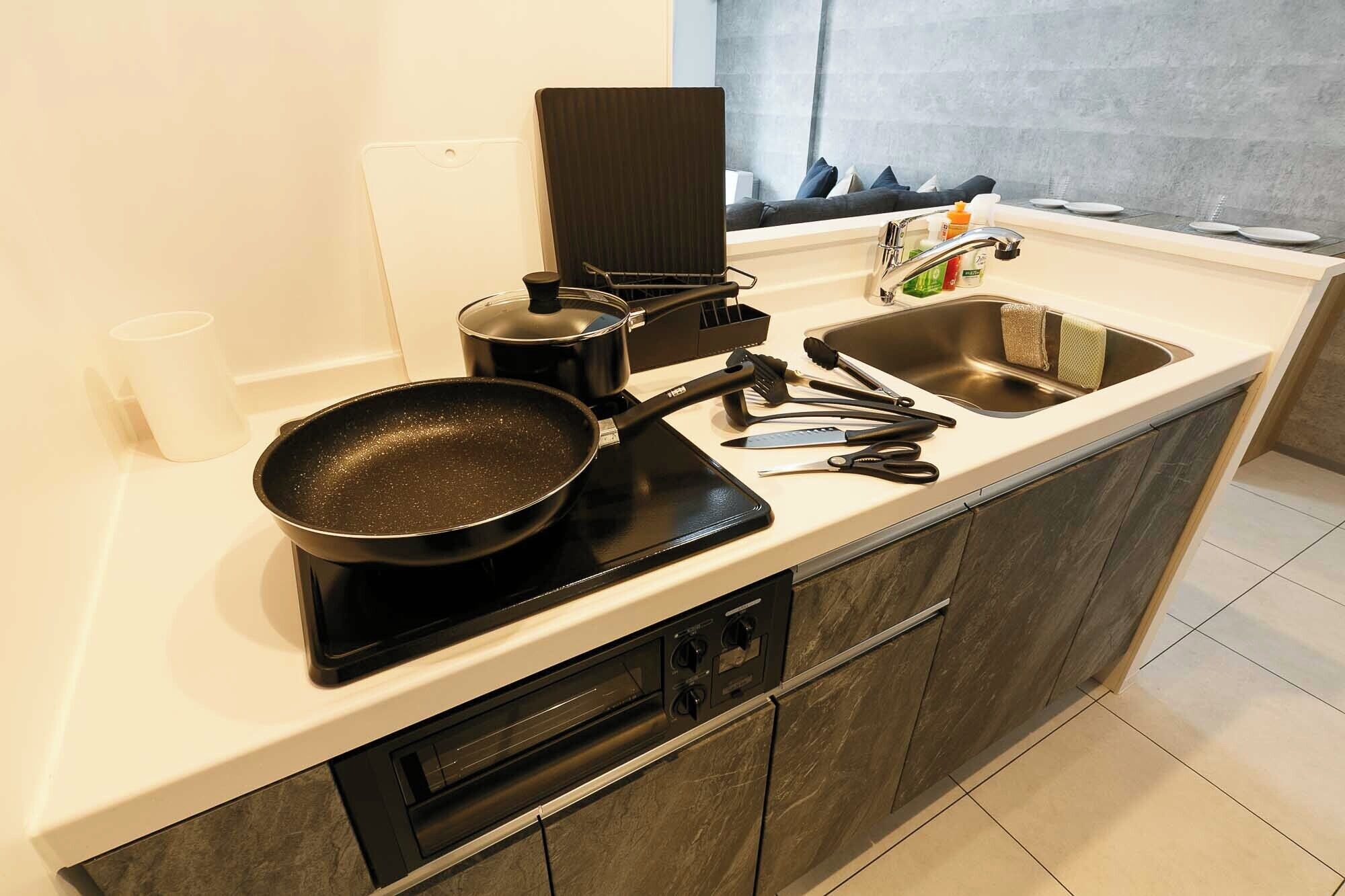 A modern kitchen with a built-in stove, a sink, and a window with a view.