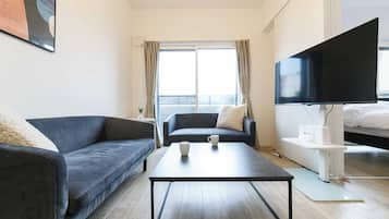 Deluxe Room, Non Smoking (206) | Living area | Flat-screen TV