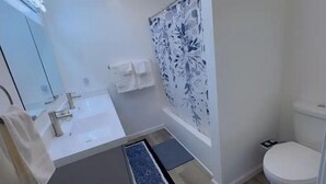 A bathroom with a white sink, mirror, and toilet. - Quiet 2BR-Retreat Near Alum Creek & Lewis Center (Delaware)