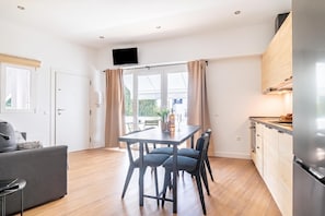 A modern kitchen with a built-in oven and a dining area with a table and chairs. - Calahonda Beach A, Mijas Costa, Spain (Mijas Costa)
