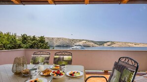 A table set with breakfast items and a view of a boat on a lake. - Sea and Silence Apt /w Sea View Balcony, Lopar, Croatia (Lopar)
