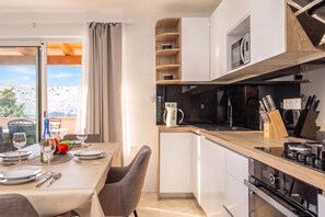 A modern kitchen with a built-in oven, microwave, and a coffee machine. - Sea and Silence Apt /w Sea View Balcony, Lopar, Croatia (Lopar)