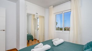 A hotel room with a bed, a window with a view, and a door leading to another room. - El Faro Hideaway by Lica Homes (Mijas)