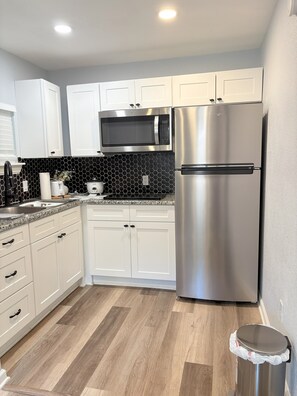 Fridge, microwave, stovetop, coffee/tea maker