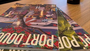 A magazine on a table with a view of a living room in the background.