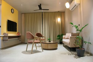 Luxury Apartment | Living area | 32-inch flat-screen TV with satellite channels, TV