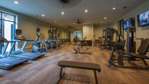 A gym with treadmills, elliptical machines, and weight equipment. - Peony At Millennium - Elegant 2 BDR in Houston (Houston)