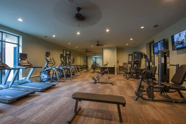 A gym with treadmills, elliptical machines, and weight equipment. - Peony At Millennium - Elegant 2 BDR in Houston (Houston)