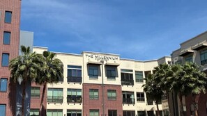 A building with the sign 'The Millennium' on the facade, featuring multiple windows and a modern architectural style.