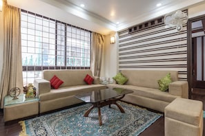 Deluxe Apartment | Living area | 36-inch LED TV with digital channels
