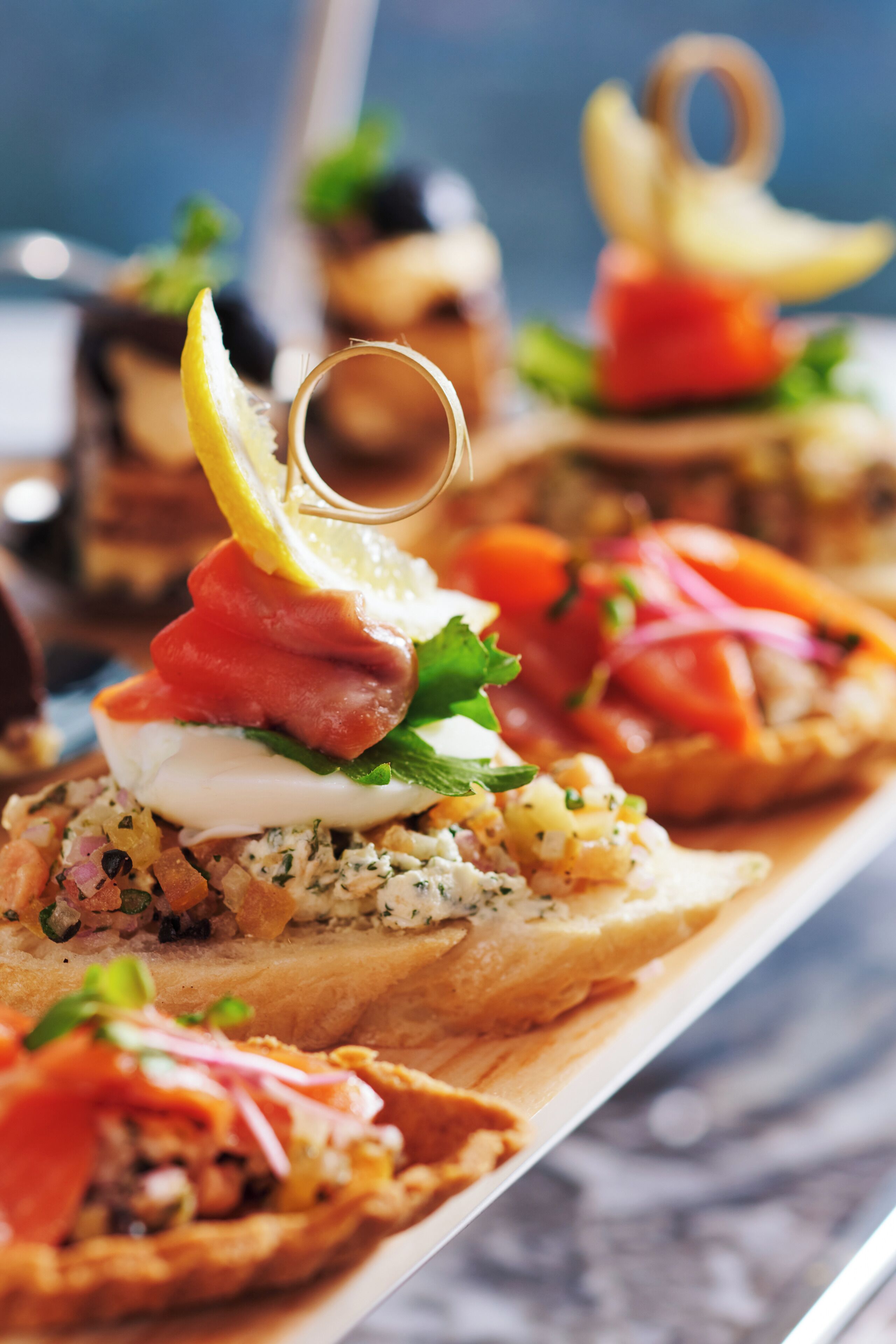 A tray of appetizers with various toppings and garnishes.