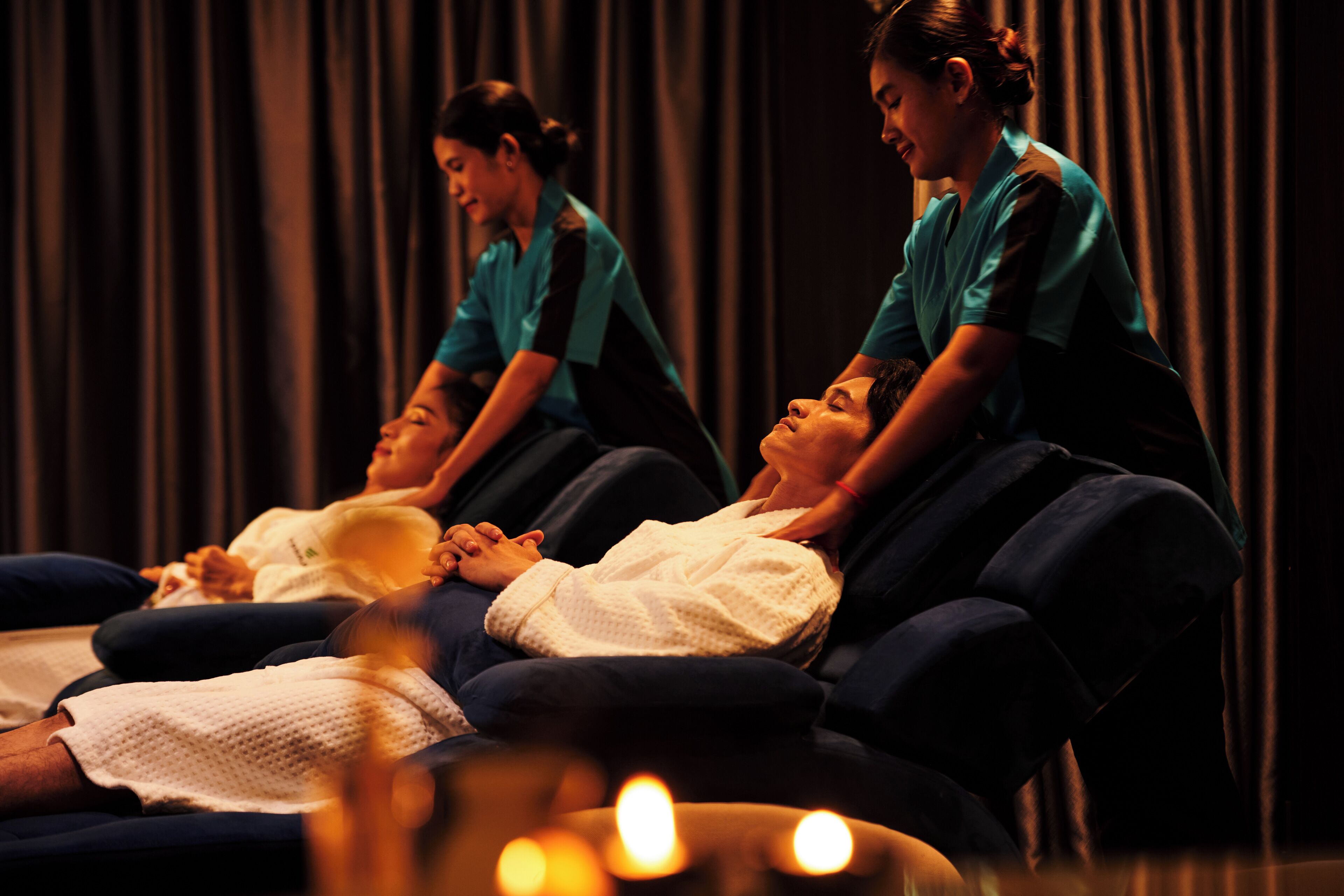 A massage therapy room with two clients receiving treatment.