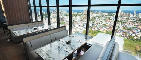 A modern interior with a large window offering a city view.