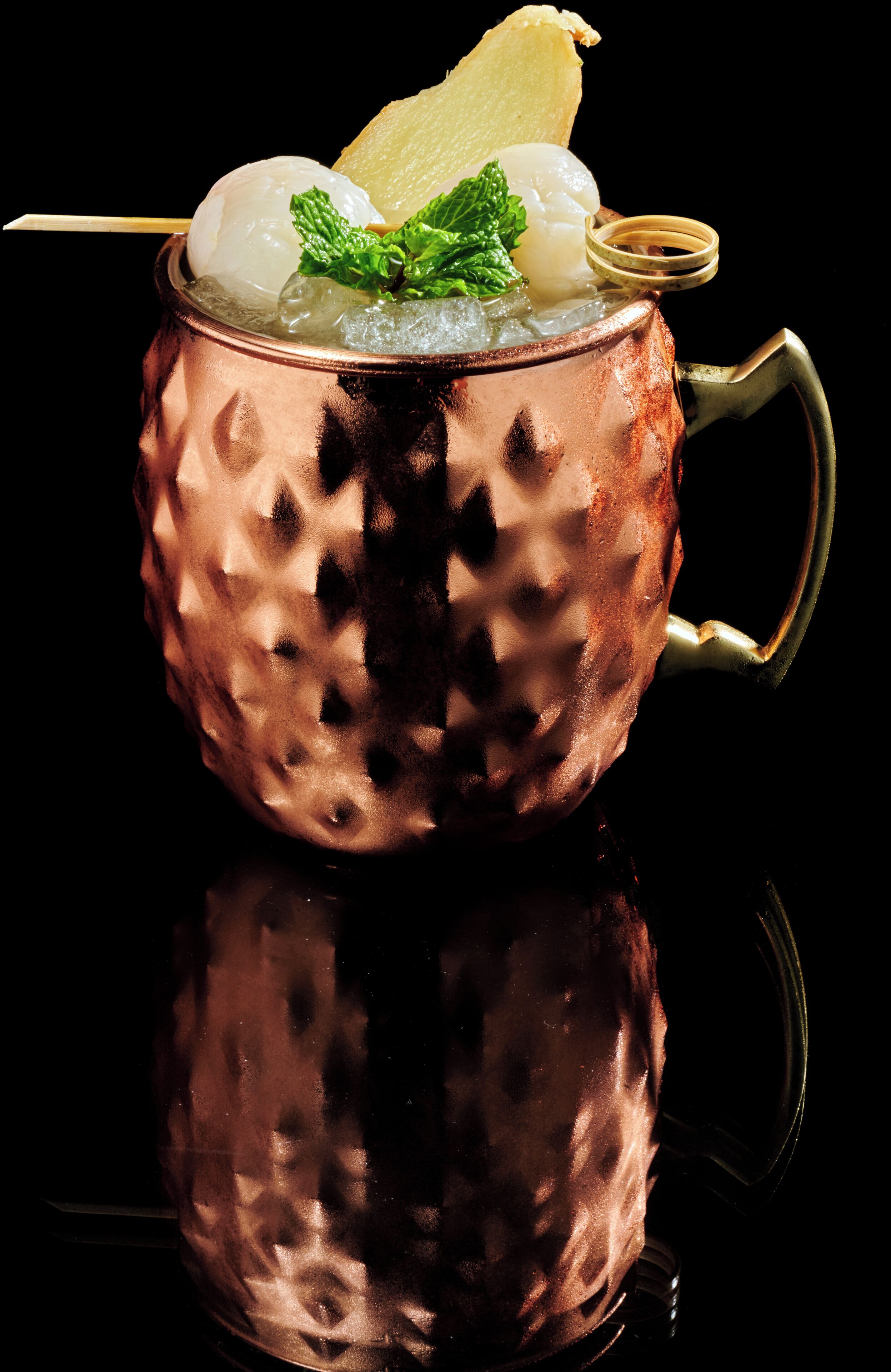 A copper mug with a lemon slice and mint garnish.