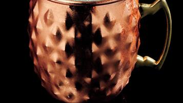 A copper mug with a lemon slice and mint garnish.