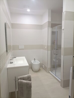 Shower, eco-friendly toiletries, hair dryer, bidet