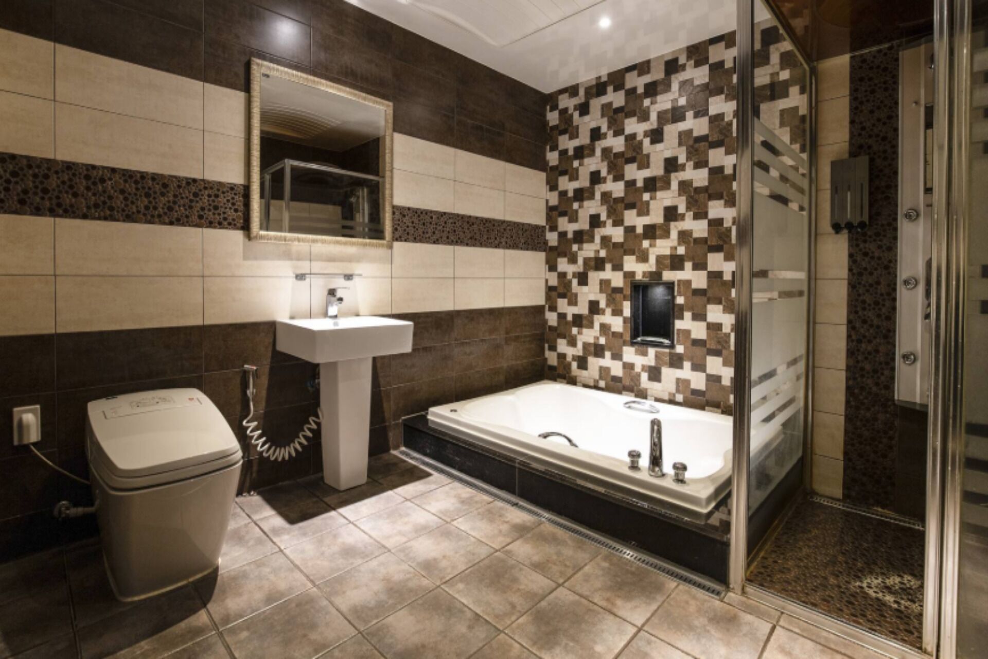 A modern bathroom with a bathtub, a sink, and a toilet.
