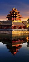A traditional Chinese building with multiple tiers and a reflection in the water.