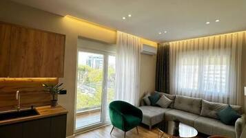 Comfort Apartment, Balcony, City View | Living room | Flat-screen TV