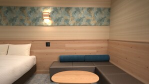 A room with a bed, a small table, a sofa, and a wall-mounted light fixture. - YUTORIA RESORT HIDATAKAYAMA (Takayama)