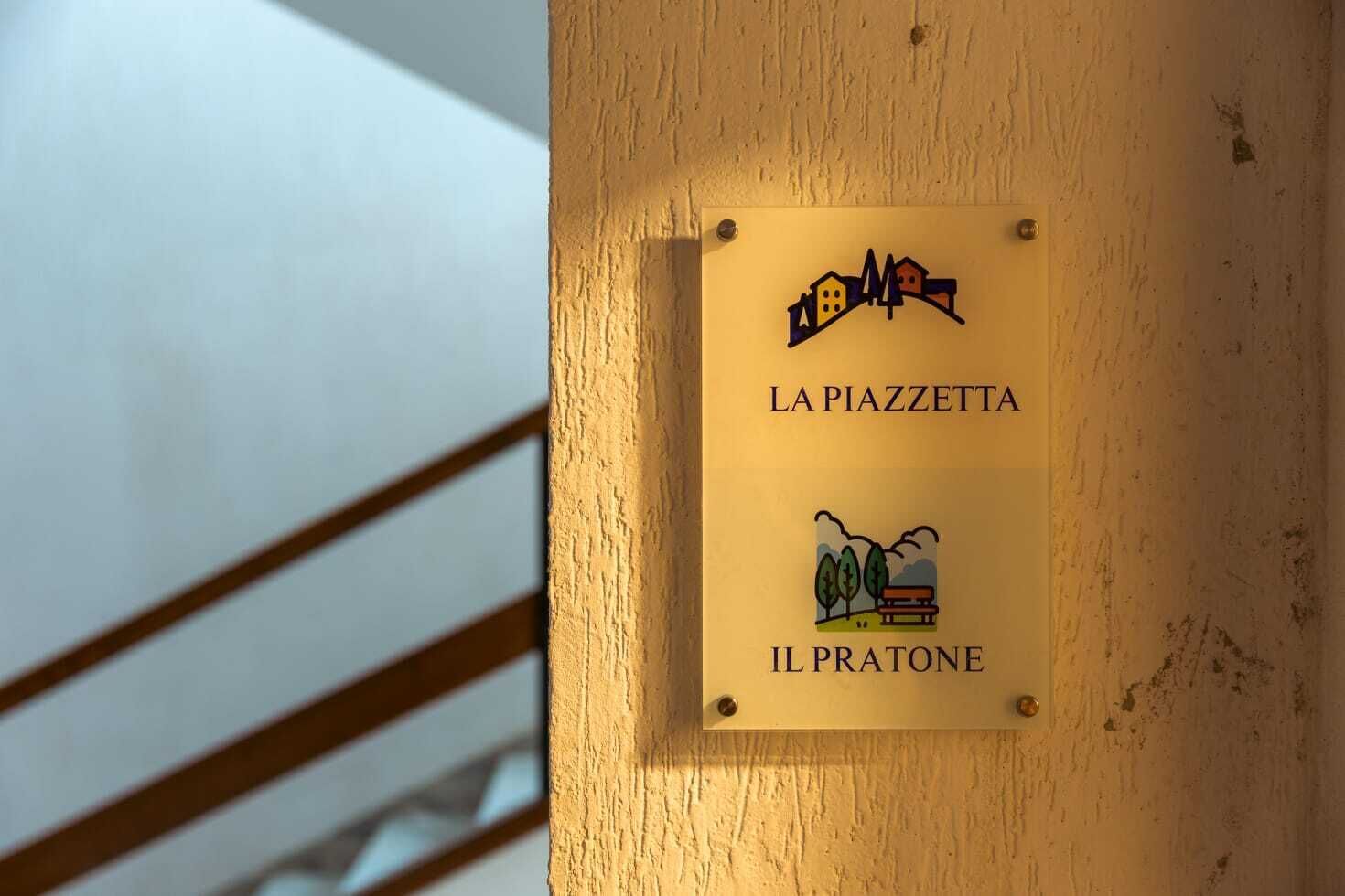 A sign with 'LA PIAZZETTA' and 'IL PRATONE' indicating a location or area.