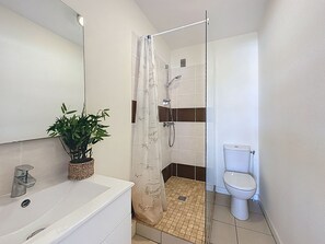 Ein modernes Badezimmer mit Dusche, Toilette und Waschbecken.
