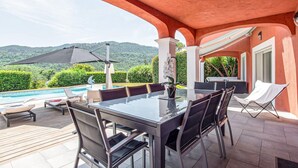 An outdoor patio with a pool, dining table, chairs, and a grill area. - Gorgeous home in Les Adrets-de-l'Estére (les Adrets-de-l'Estére)