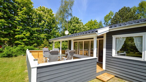 A small, single-story cabin with a covered patio area.
