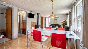 A modern kitchen with a large island, red chairs, and a black leather sofa. - 3 bedroom stunning home in Tarm (Tarm)