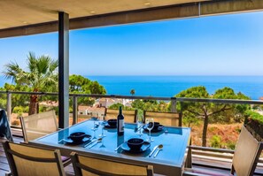 A dining table set for two with a view of the sea. - Punta Paloma 2451 Mediterranean-View (Manilva)