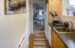 Fridge, stovetop, dishwasher, coffee/tea maker