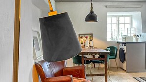A dining area with a table, chairs, and a hanging lamp. - Stunning home in Slite with WiFi (Slite)