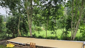 A large, flat, open area with a wooden structure and a yellow bag. - La Fée Vacation Rental in Monadière near La Chaise-Dieu, with a 15x8 pool (LA CHAPELLE GENESTE)