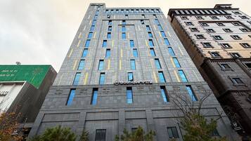 A modern building with a prominent sign for Boutique Muynak.