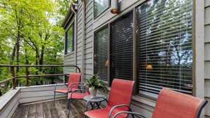 A wooden deck with four red chairs and a potted plant. - Dobie 36  with Wintergreen Advantage (Wintergreen)